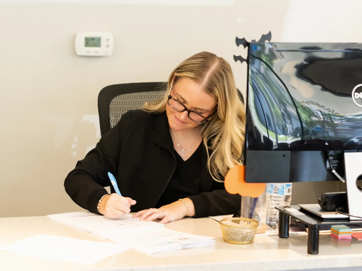 Woman sitting at desk writing